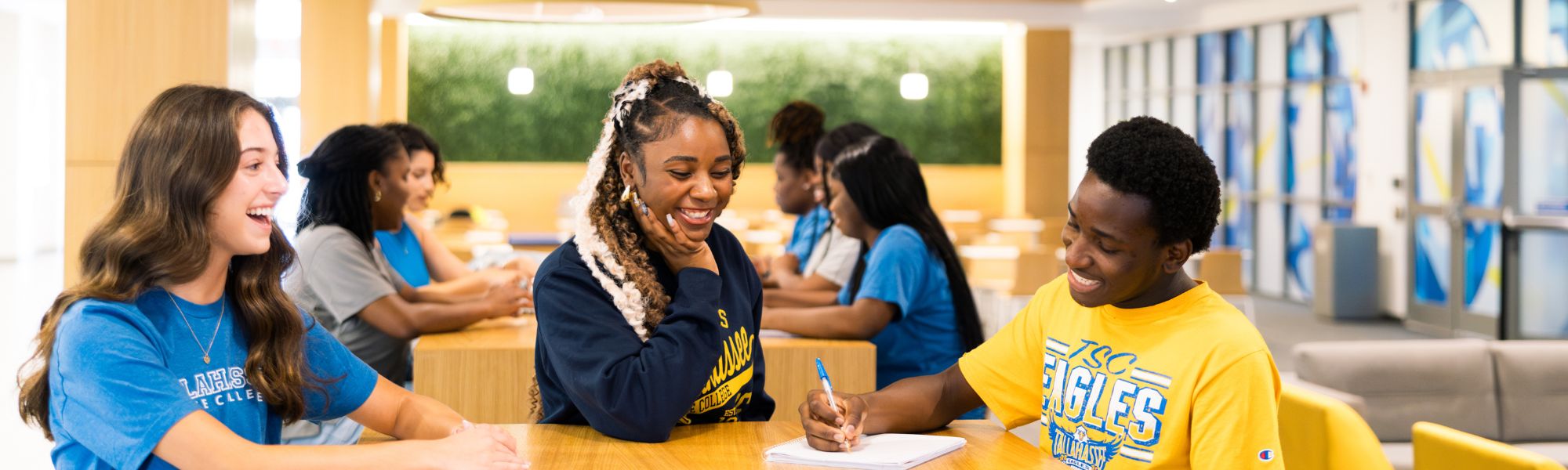TSC students sitting together under the Student Union staircase.