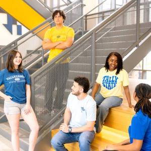 TSC students sitting around the Student Union staircase.