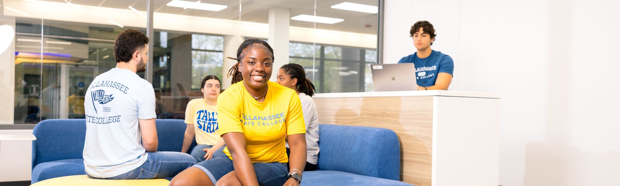 Smiling TSC student in bright yellow shirt.