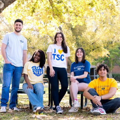 Group of TSC students sitting and smiling together.