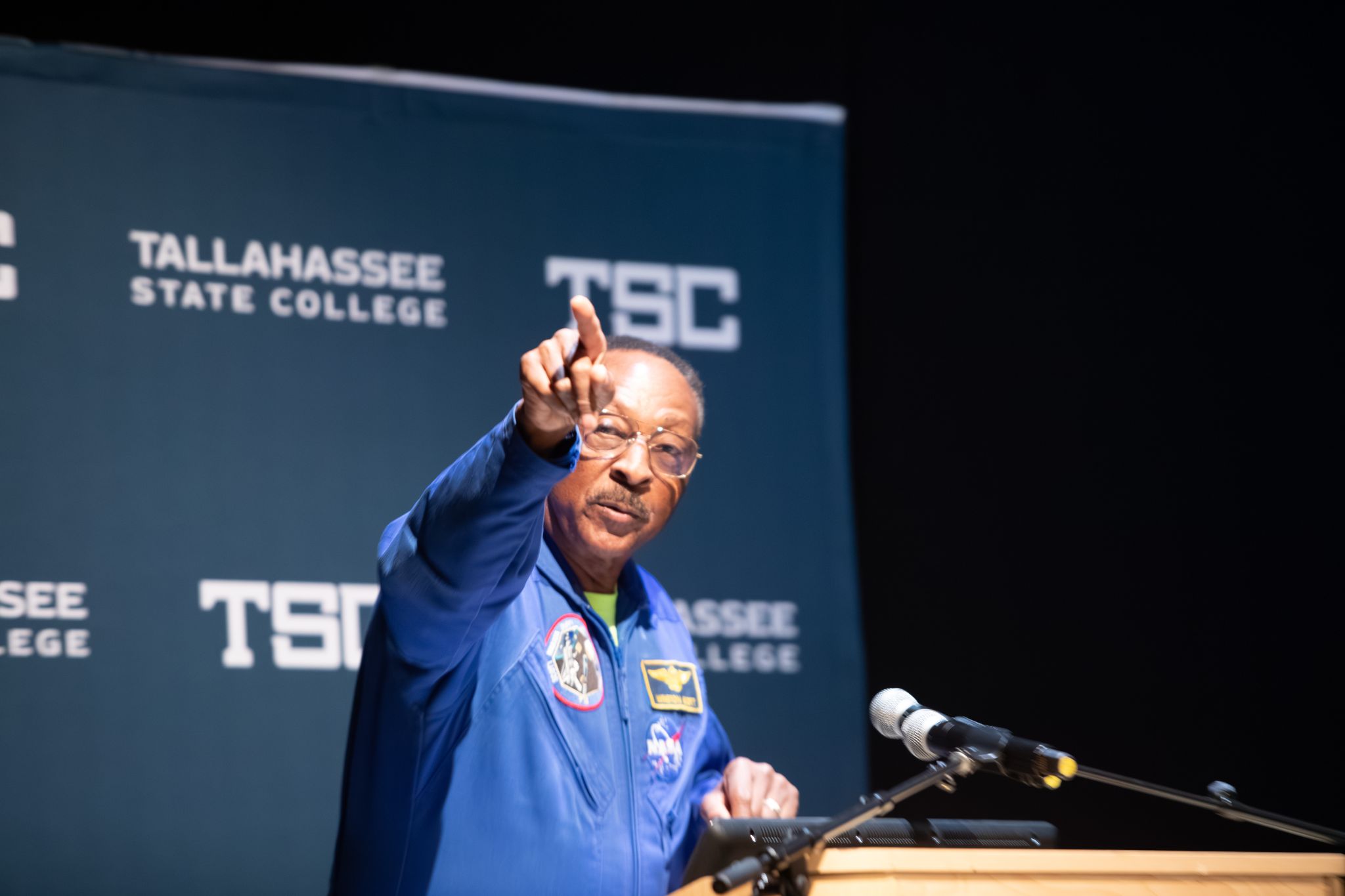 Captain Winston Scott pointing upward during his keynote.