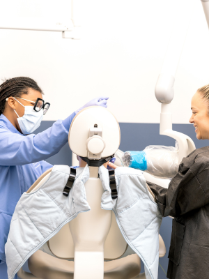 teacher and dental student practicing on doll