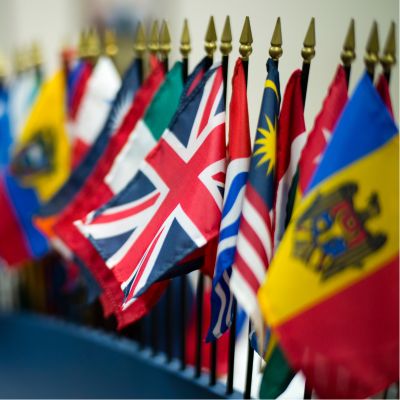 Uk and US flags held by students in a parade