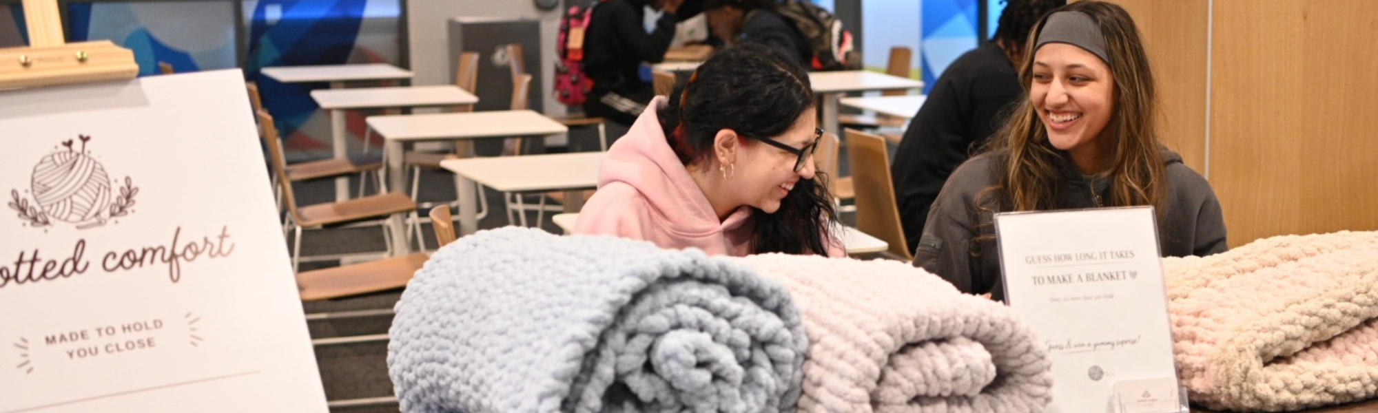 Two student vendors selling blankets at Market Wednesday event.