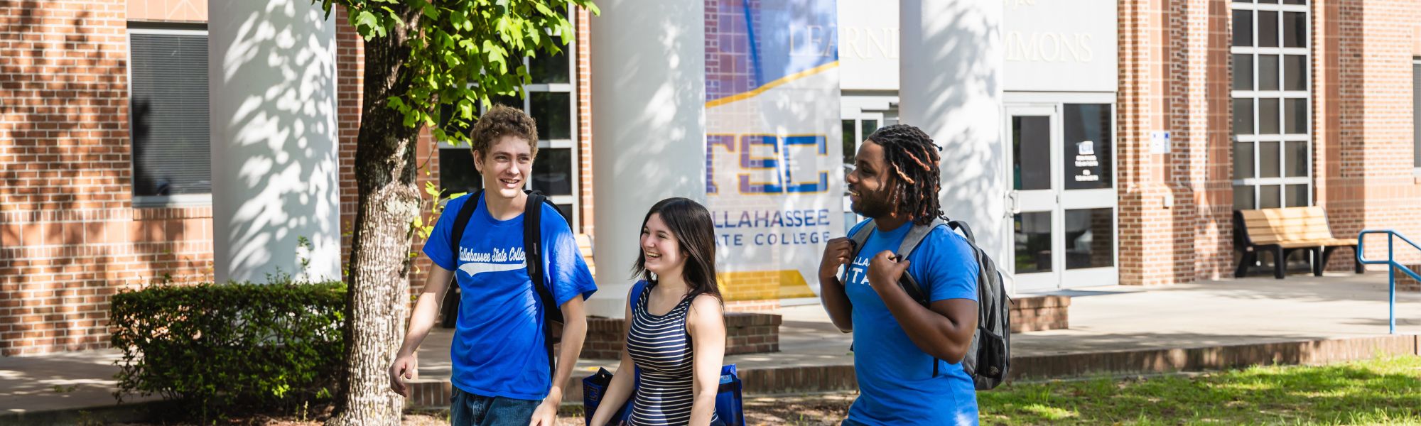 TSC students walking in front of the Learning Commons building together.